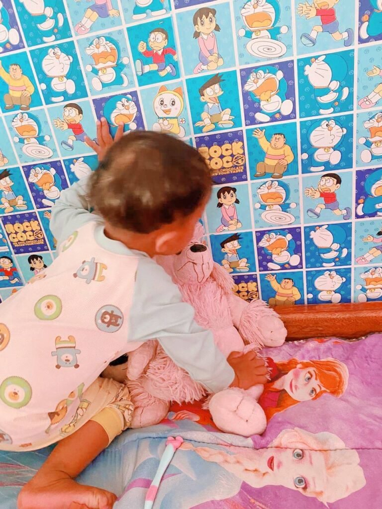 Toddler hugging his favorite pink stuffed animal after a successful toothbrushing routine, showing a positive association with dental care.