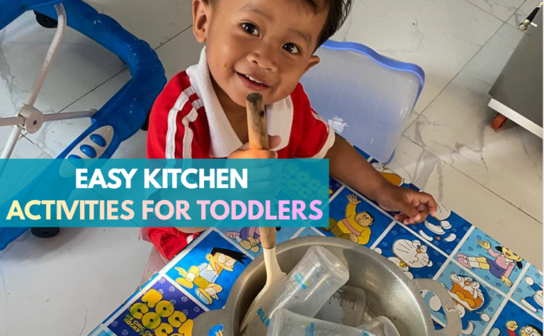 Toddler boy sitting at a table stirring empty milk bottles in an aluminum pot for a pretend play activity.