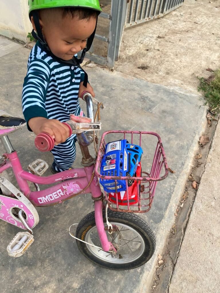 Toddler looking down at toys in the front basket, demonstrating how visual control solves resistance to change.