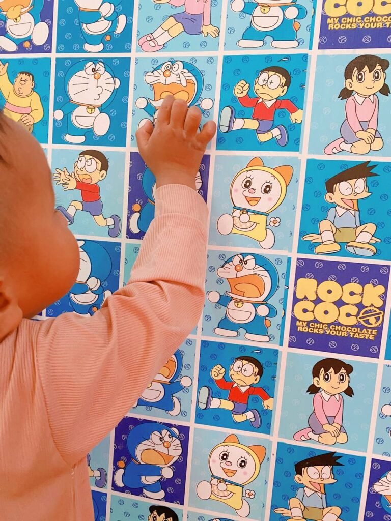 Toddler pointing to a loud, shouting cartoon character to learn about using indoor voices.