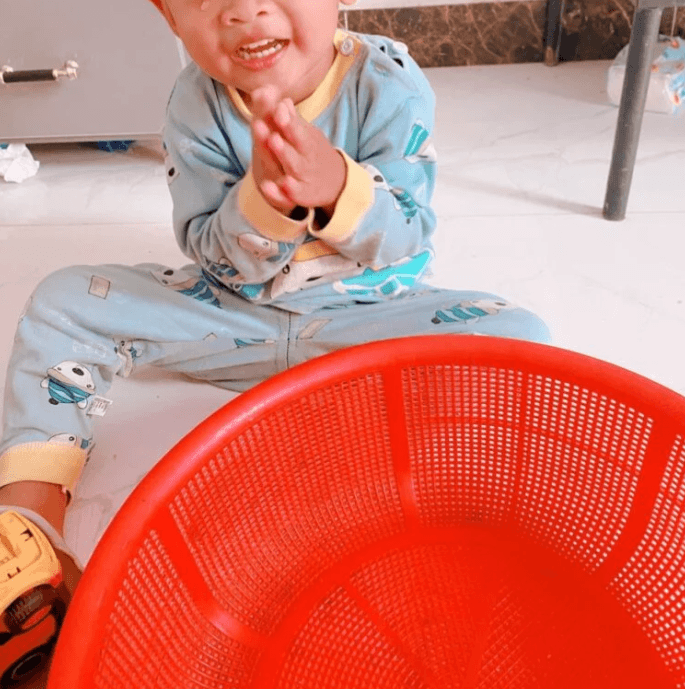 Toddler clasping hands together in a begging gesture asking for help finding a lost toy.