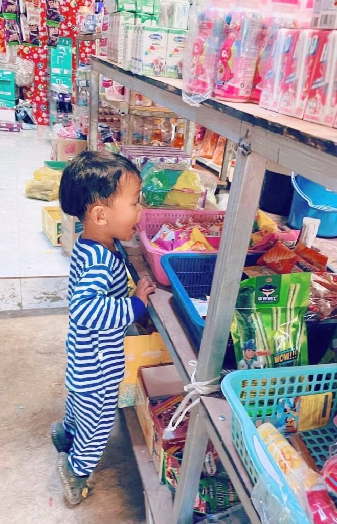 Young child staring at snacks in a grocery aisle, about to ask for a treat.