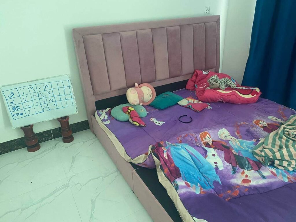 A visual schedule for kids drawn on a small whiteboard, placed right next to a child's bed for easy daily access.